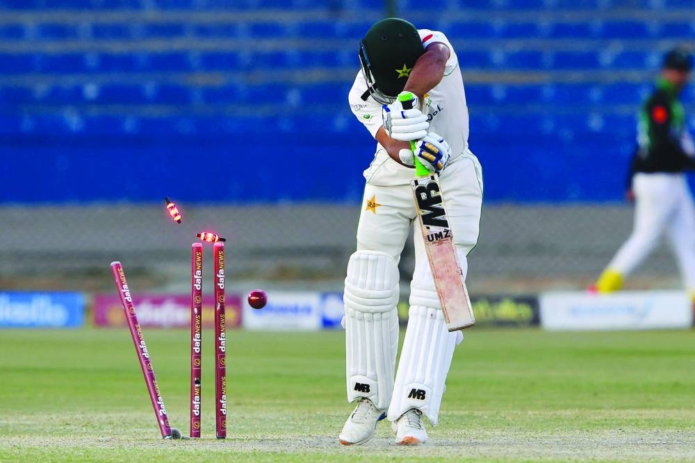 Pakistan's Abdullah Shafique is clean bowled by New Zealand's captain Tim Southee (not pictured) during the fourth day of the second Test at the National Stadium in Karachi yesterday. (AFP)