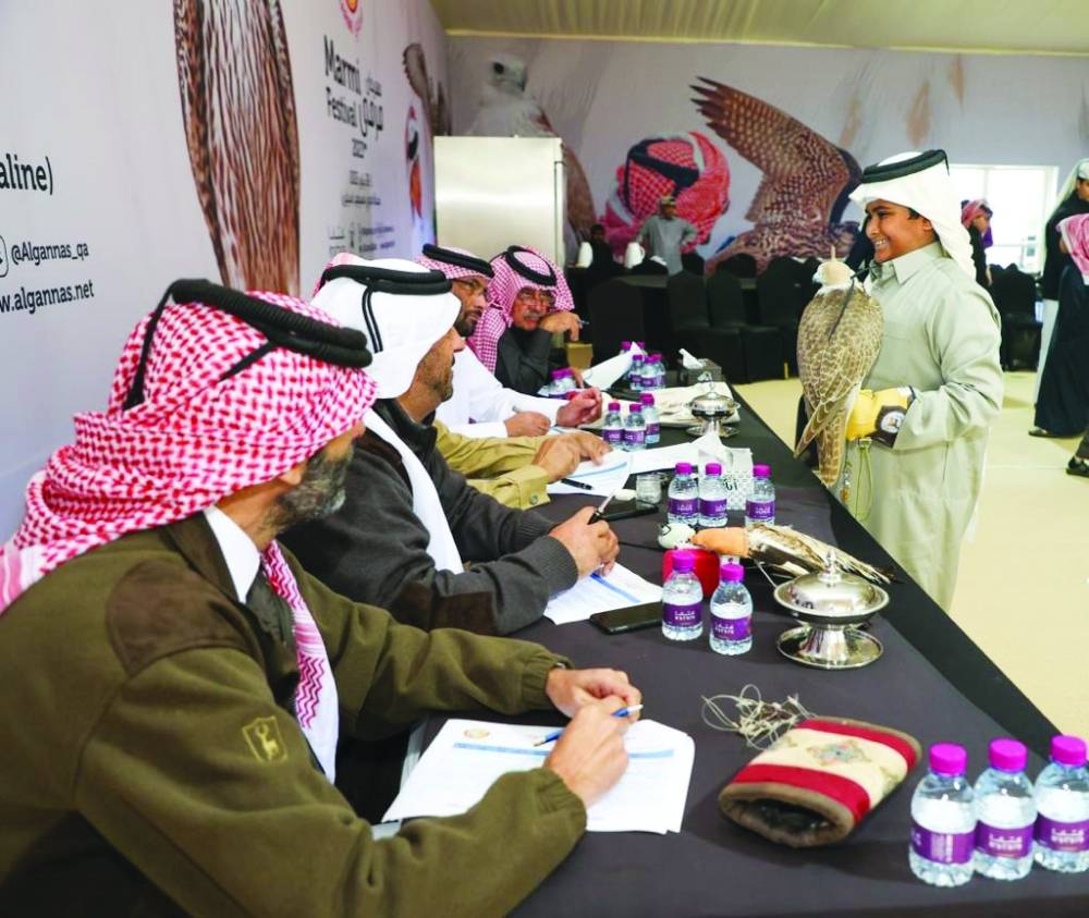 A young falconer interacting with jury