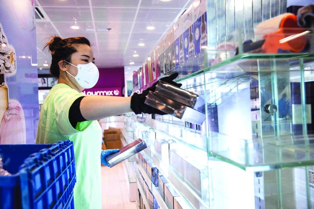 A worker stocks shelves in a shop at Lok Ma Chau station at the Shenzhen border crossing with mainland China in Hong Kong. 