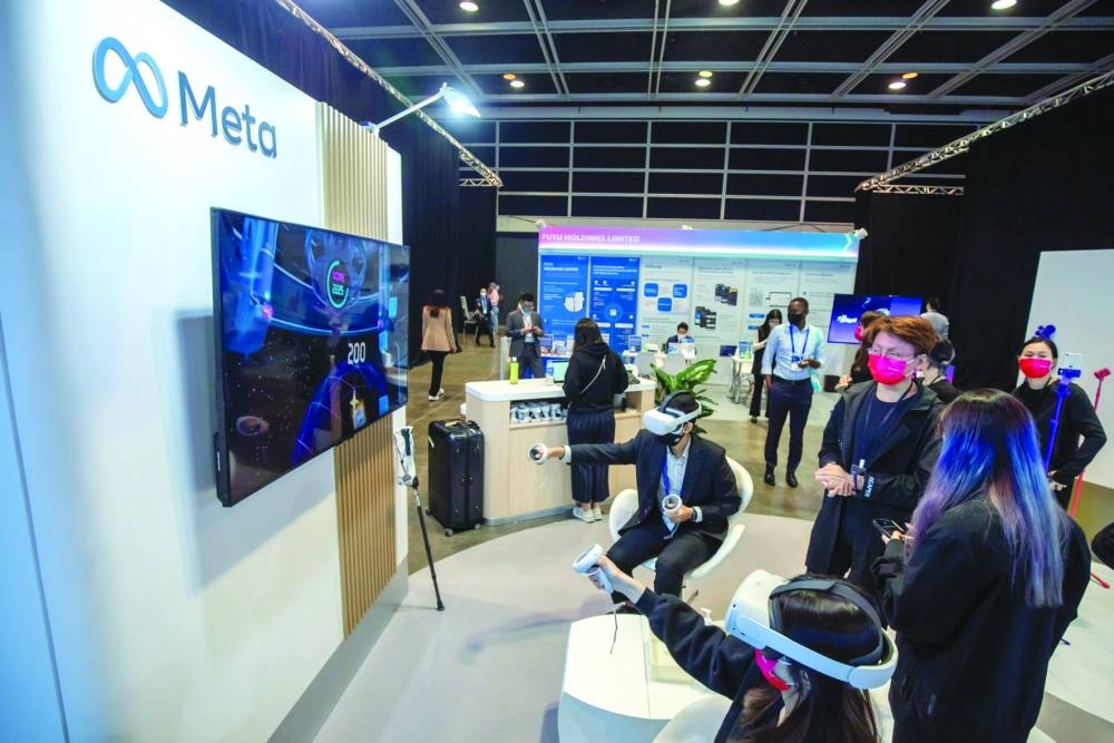 Attendees at the Meta Platforms booth during the Hong Kong Fintech Week in Hong Kong (file). Tech companies including Microsoft Corp and Meta Platforms are expected to hit the bond market in size to buy back stock after last year’s rout.