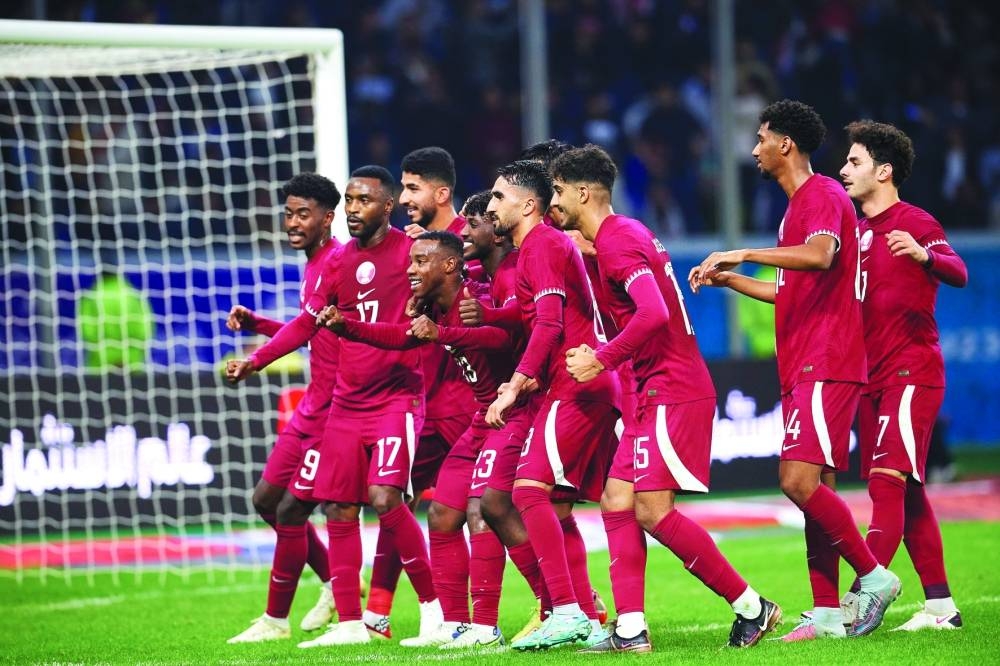 Qatar players celebrate after their 2-0 victory over Kuwait in the 25th Arabian Gulf Cup opener in Basra, Iraq, Saturday. At the new-built Al Minaa Olympic Stadium, Amro Siraj and Ahmed Alaaeldin scored for the three-time champions in the first half of the game. 