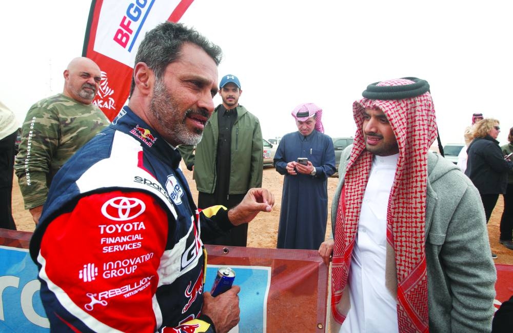 Qatar’s Toyota Gazoo Racing driver Nasser al-Attiyah with Director of the QOC Ultimate Race Sheikh Suhaim bin Mohamed al-Thani during the seventh stage of the Dakar Rally in Riyadh yesterday. (Reuters)