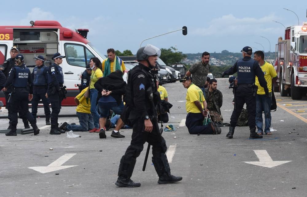 Security forces arrest supporters of Brazilian former President Jair Bolsonaro after retaking control of Planalto Presidential Palace (AFP)