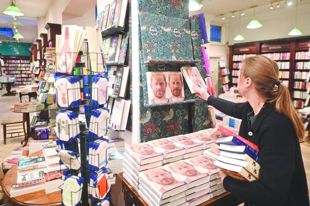 A bookseller prepares a display for 'Spare' by Britain's Prince Harry, at Daunt Books on Marylebone High Street in London Tuesday. 