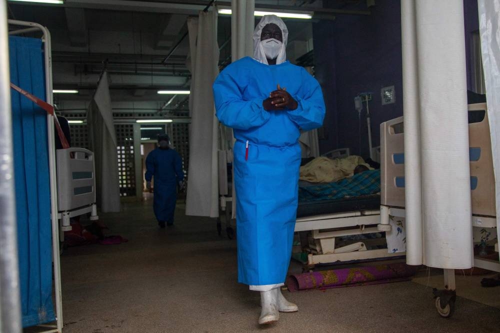 In this file photo taken on September 24, 2022 a member of the Ugandan Medical staff of the Ebola Treatment Unit stands inside the ward in Personal Protective Equipment. (AFP)