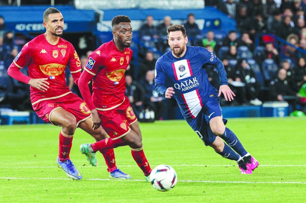 Paris Saint-Germain’s Lionel Messi (right) vies for the ball with Angers’ Abdoulaye Bamba (centre) and Cedric Hountondji during the Ligue 1 match. (AFP)