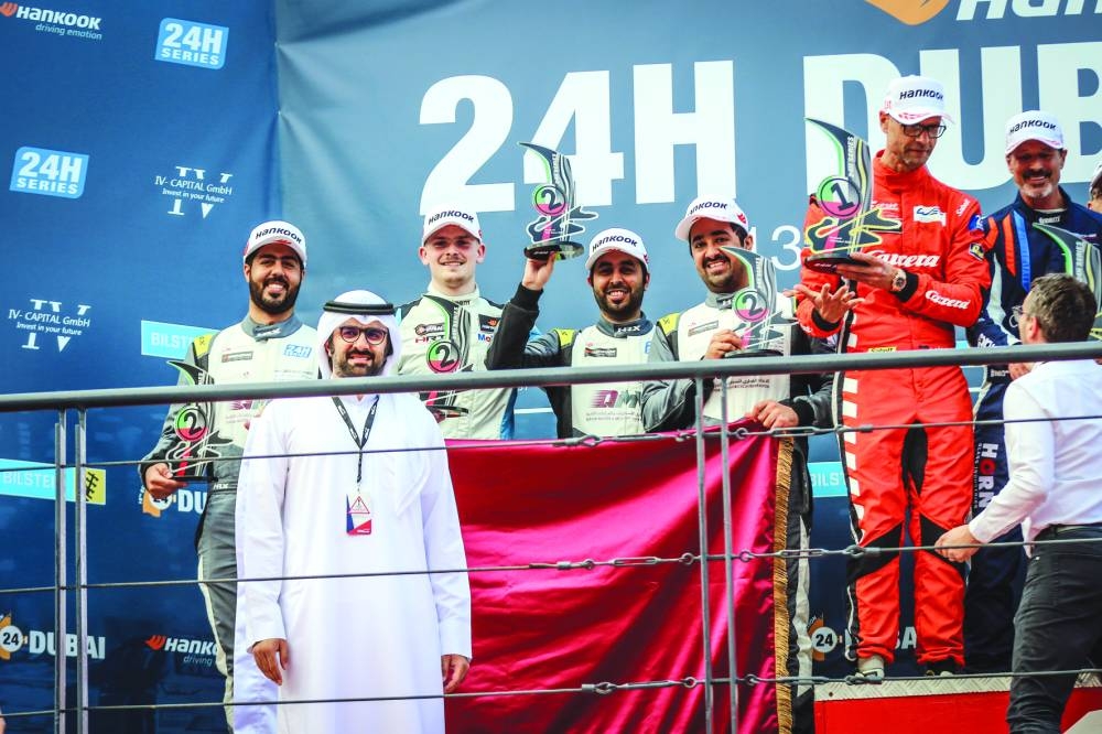 Team Thuraya drivers celebrate on the podium. 