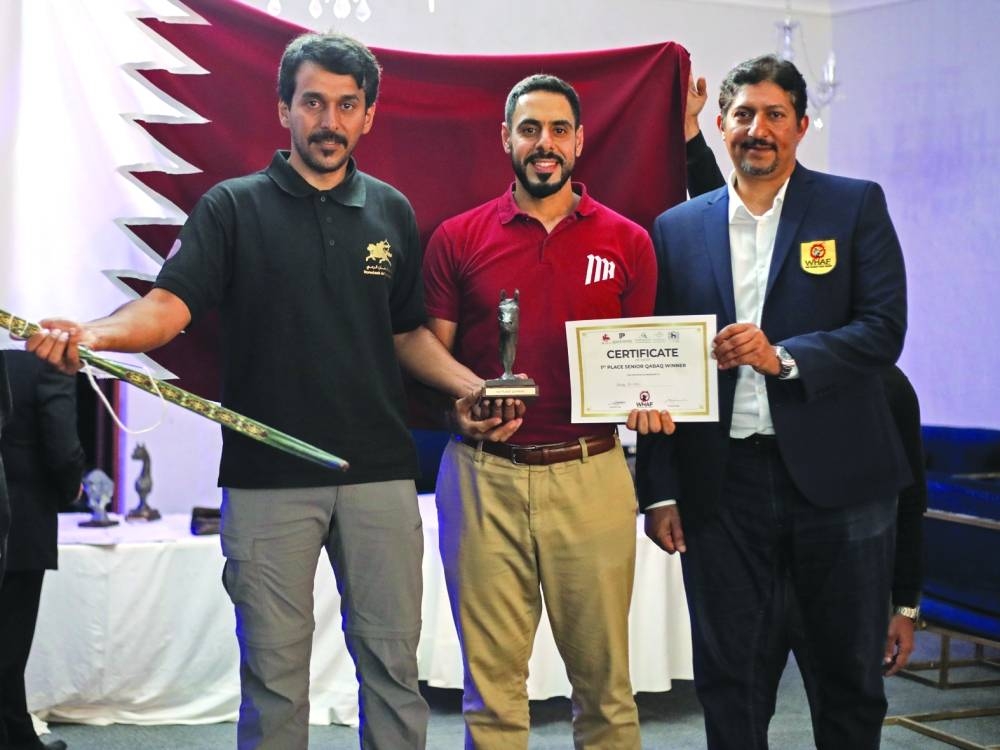 Badr Mubarak al-Marri, in middle with Fuad al-Mudahka member of the WHAF, right, and team mate, left.