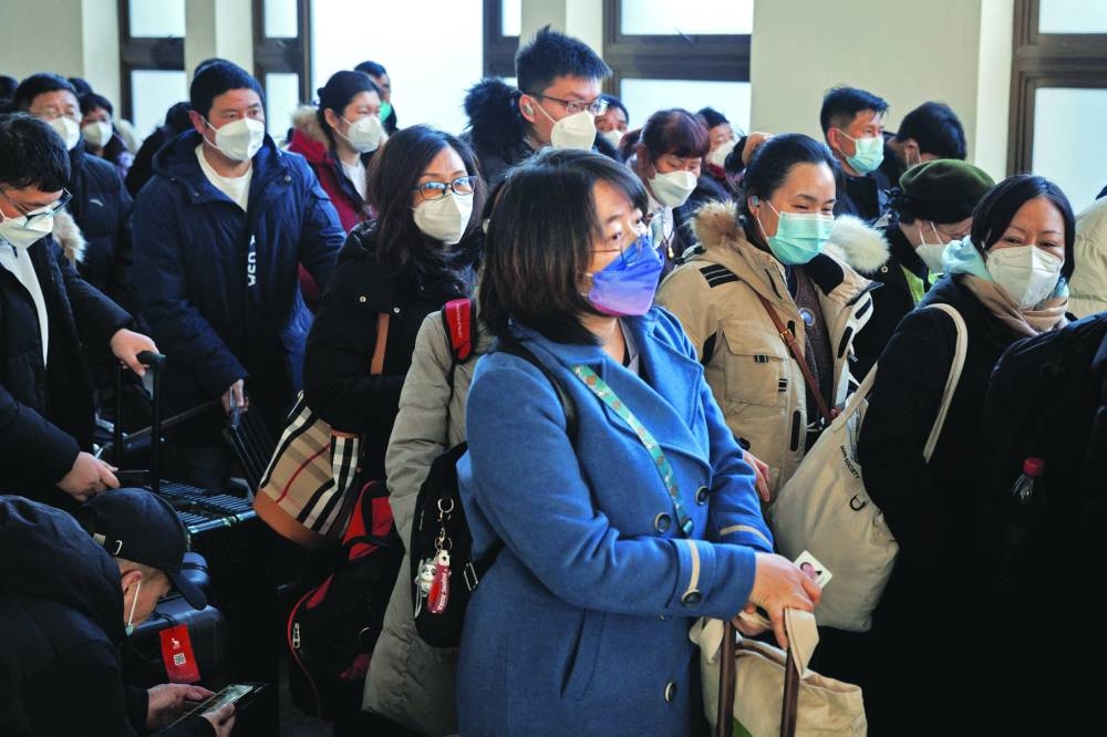 Passengers wait to board a train to travel for Spring Festival ahead of Chinese Lunar New Year festivities after China lifted its Covid-19 restrictions in Beijing.