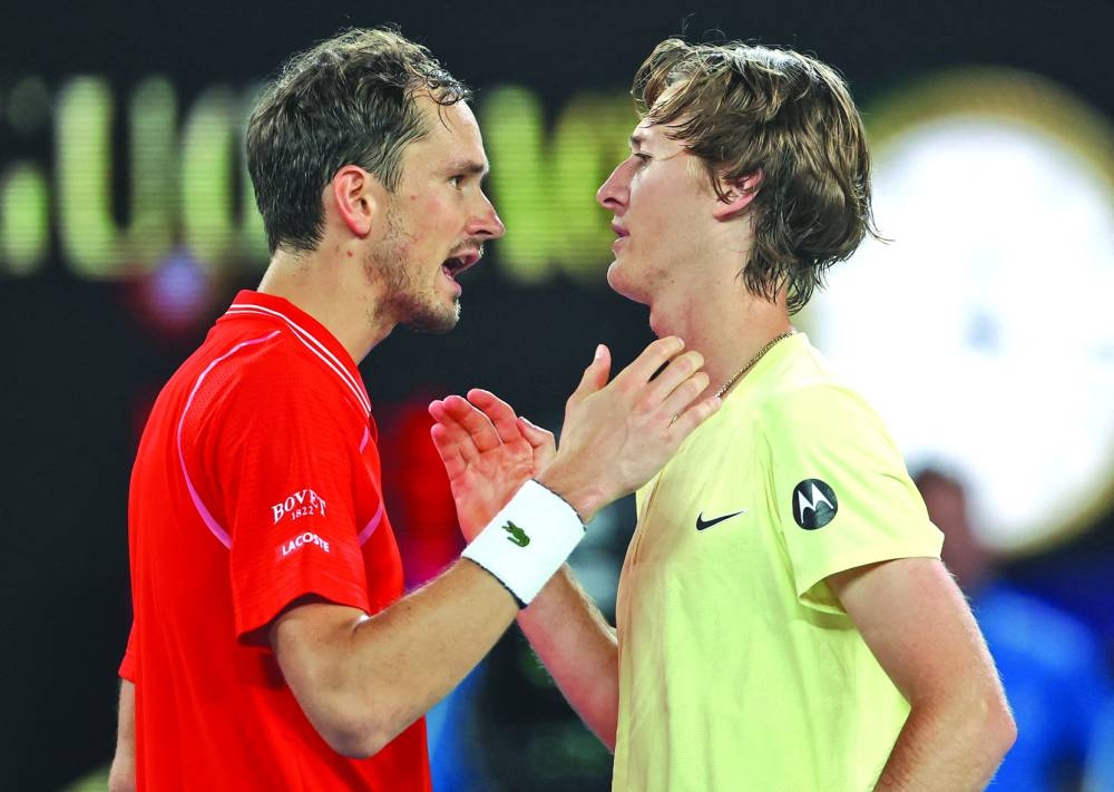Sebastian Korda of the US shakes hands with Russia's Daniil Medvedev after winning his third round match at Melbourne Park, Melbourne, Australia, on Friday. (Reuters)