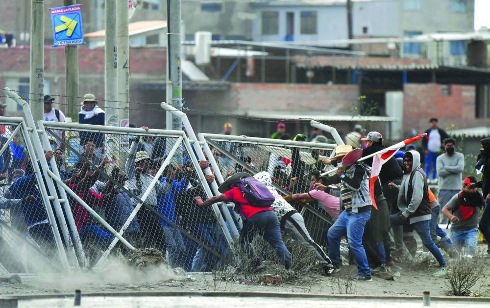 Demonstrators pull down a fence at the Rodriguez Ballon airport in Arequipa, Peru, during a protest against the government of President Dina Boluarte.