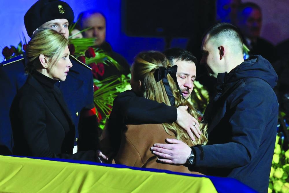 Ukrainian President Volodymyr Zelensky (centre) and his wife Olena (left) offer relatives their condolences during the funeral ceremony of Interior Minister Denys Monastyrsky and other employees of his department at the Ukrainian House in Kyiv yesterday. (AFP)