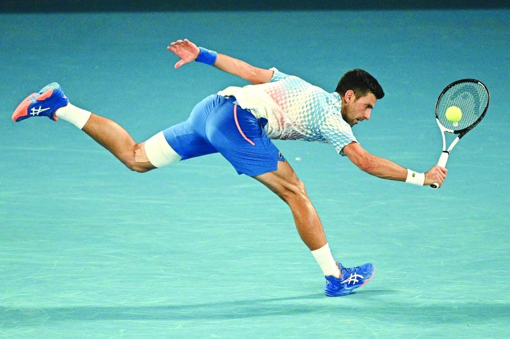 Serbia’s Novak Djokovic stretches for a return during his Australian Open fourth round match against Australia’s Alex de Minaur in Melbourne yesterday. (AFP)