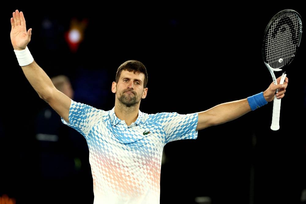 TOPSHOT - Serbia's Novak Djokovic celebrates victory against Russia's Andrey Rublev during their men's singles quarter-final match on day ten of the Australian Open tennis tournament in Melbourne on January 25, 2023. (AFP)