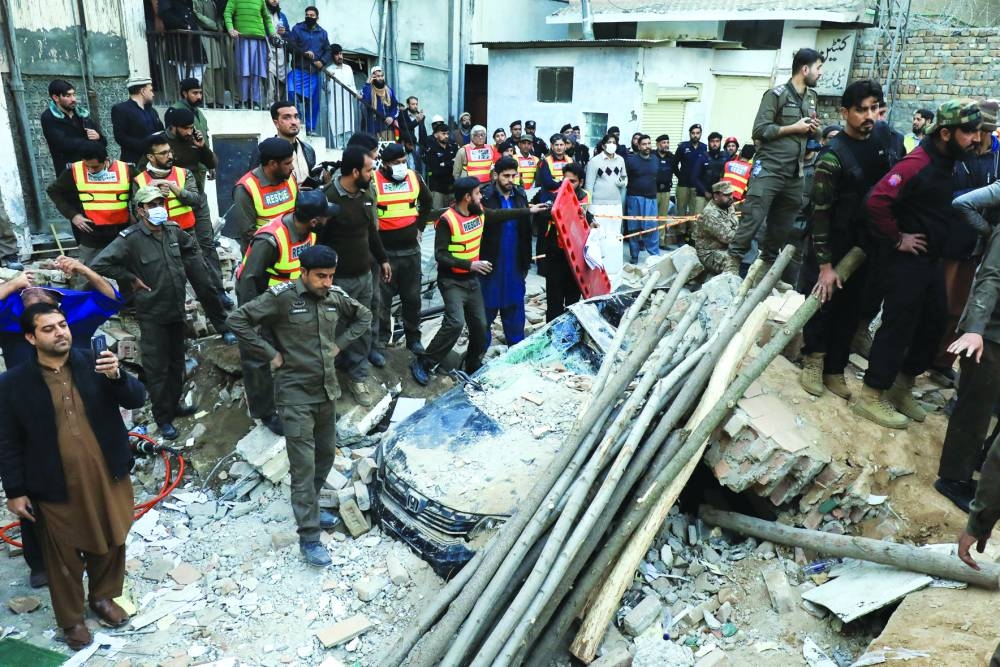 People and rescue workers gather in the mosque in Peshawar after the blast. (Reuters)