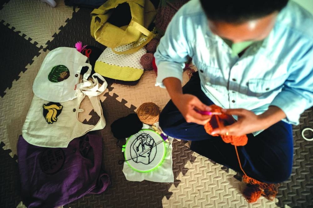 A middle-school teacher who joined the Civil Disobedience Movement (CDM) in Myanmar, crochets during an interview with Reuters in an undisclosed location, Thailand.