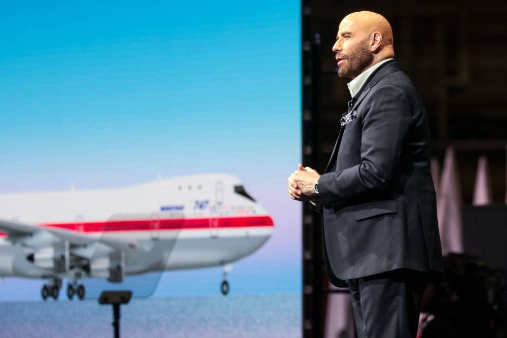 Actor John Travolta, who is a licensed pilot, speaks during a ceremony to mark the delivery of the last Boeing 747 aircraft, at the Boeing Future of Flight Museum in Everett, Washington, on January 31. AFP