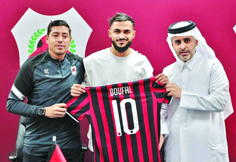 Al Rayyan’s new signing Sofiane Boufal (centre) poses with his jersey and club’s president Sheikh Ali bin Saud bin Ahmed al-Thani (right) and coach Nicolas Cordova on Wednesday.