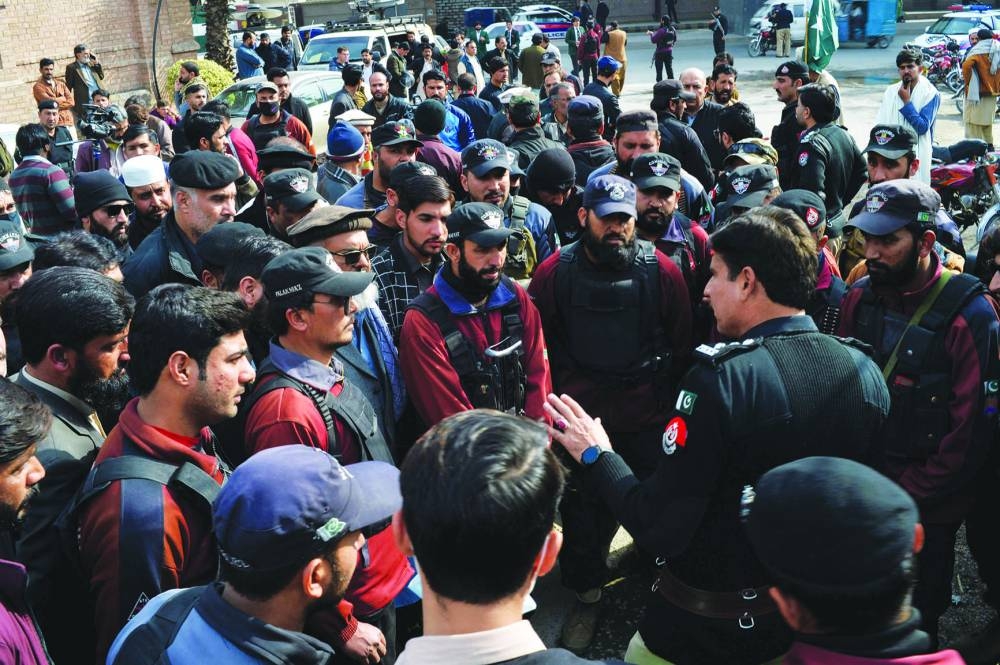In this picture taken on Wednesday, police officers gather to protest against the militancy and a mosque suicide blast inside a police headquarters in Peshawar.