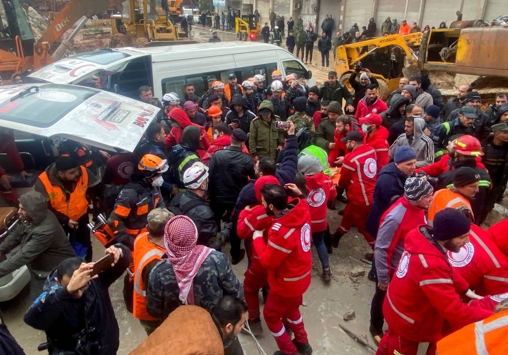 Rescuers work near the site of a collapsed building, following an earthquake, in Hama, Syria . REUTERS