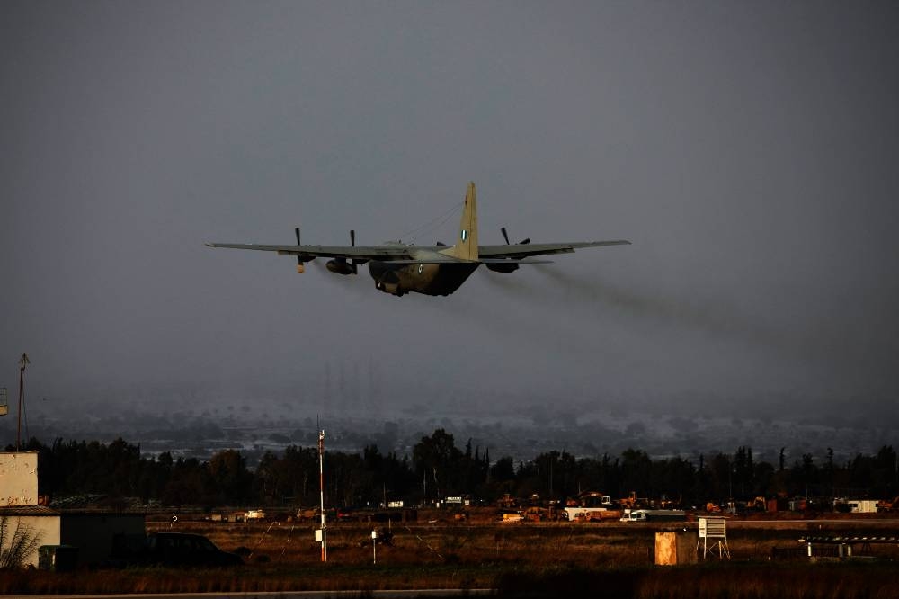 A Hellenic Air Force C-130, carrying members of a Disaster Response Special Unit who will fly to Turkey to help in the aftermath of an earthquake, departs from the military airport of Elefsina, Greece, Monday. REUTERS