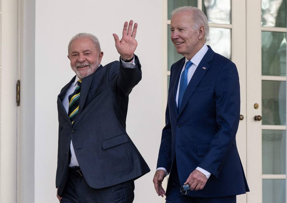 US President Joe Biden and Brazilian President Luiz Inacio Lula da Silva walk together along the Rose Garden colonnade at the White House (AFP)