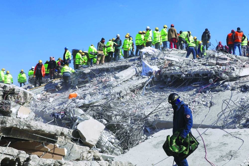 Rescuers search for survivors among destroyed buildings in Gaziantep, Turkiye Saturday. 