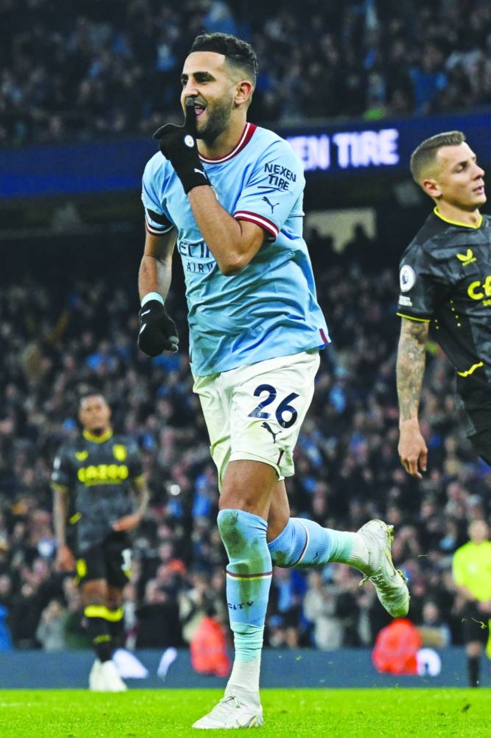 Manchester City's Riyad Mahrez celebrates after scoring their third goal during the Premier League match against Aston Villa in Manchester yesterday. (AFP)