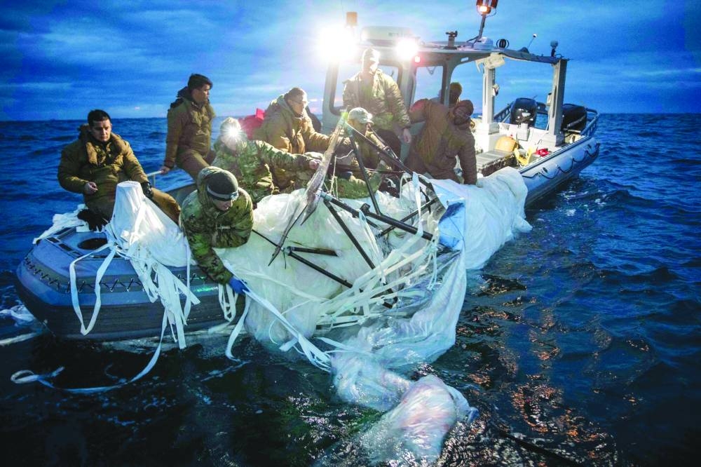 In this file photo taken on February 5, 2023 provided by the US Navy shows sailors assigned to Explosive Ordnance Disposal Group 2 recover a high-altitude surveillance balloon off the coast of Myrtle Beach, South Carolina, in the Atlantic ocean. (AFP)