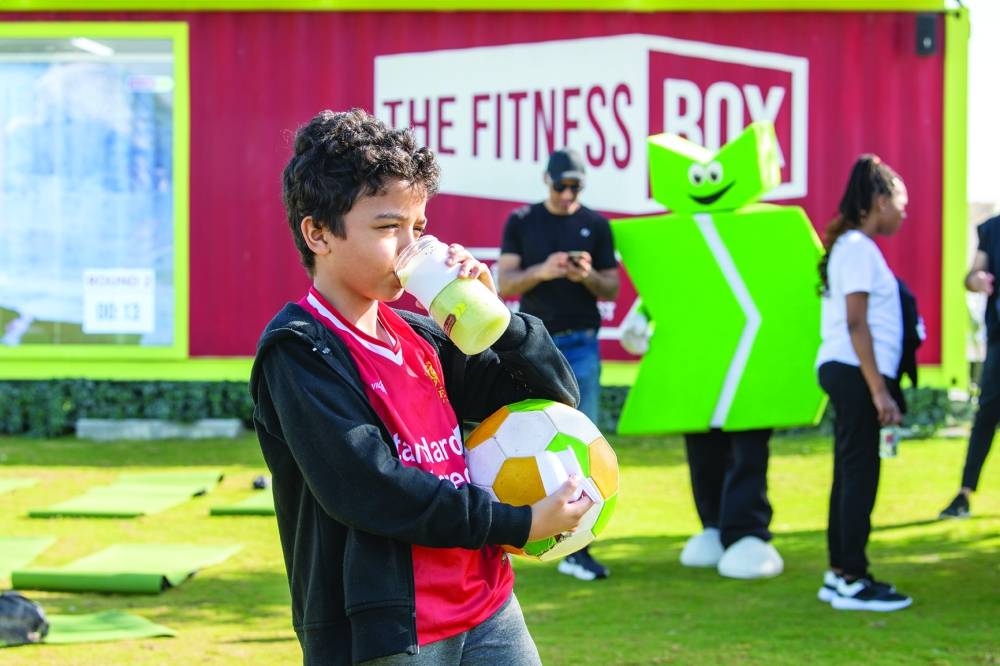 A child enjoying a smoothie after blending it on Sahtak Awalan’s smoothie bike.