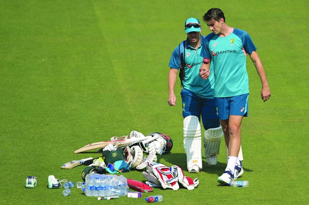 Australia’s captain Pat Cummins (right) and his teammate David Warner take part in a practice session on Wednesday. (AFP) 