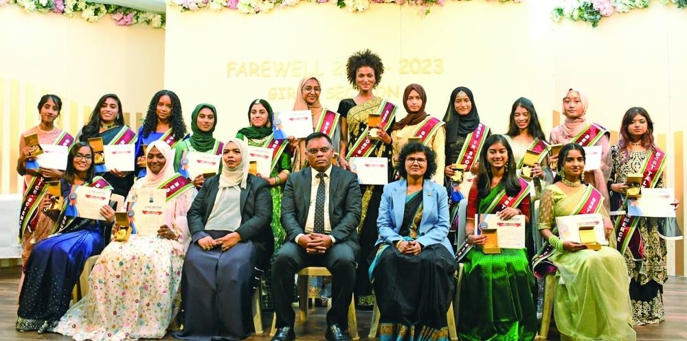 Class XII girls with officials during the farewell ceremony.