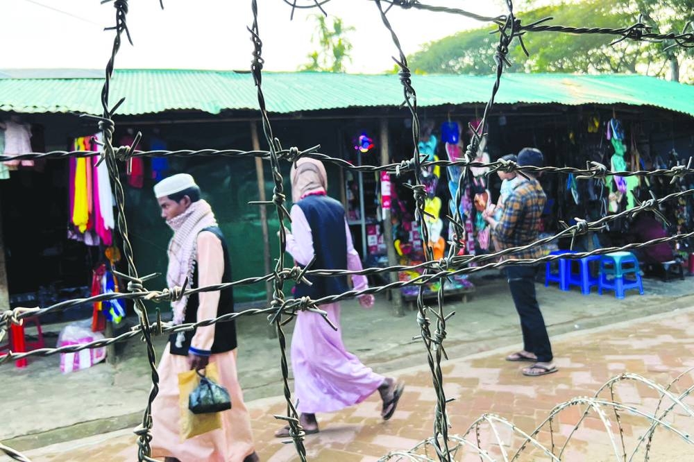 Barbed wire is seen on the side of a refugee camp in Cox’s Bazar.