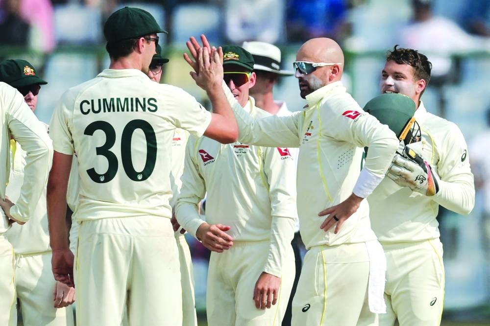 Australia's Nathan Lyon (centre right) celebrates with teammates after taking the wicket of India's KL Rahul during the second day of the second Test at the Arun Jaitley Stadium in New Delhi yesterday. (AFP)