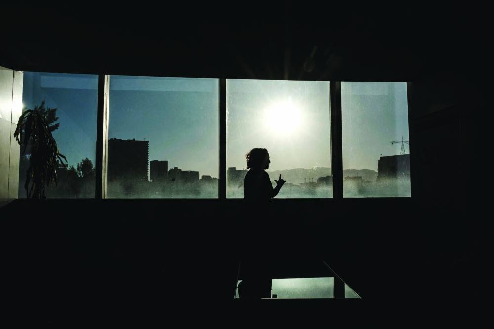 A woman stands in front of window during the second day of the 36th Ordinary Session of the Assembly of the African Union (AU) at the African Union headquarters in Addis Ababa.
