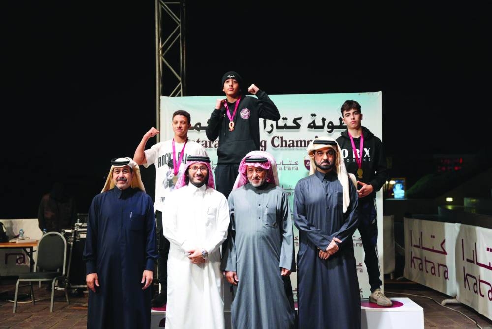 Qatar Boxing Federation president Sheikh Fahd bin Khalid al-Thani poses with boxers and officials during the podium ceremony of the 5th Katara Boxing Championships.