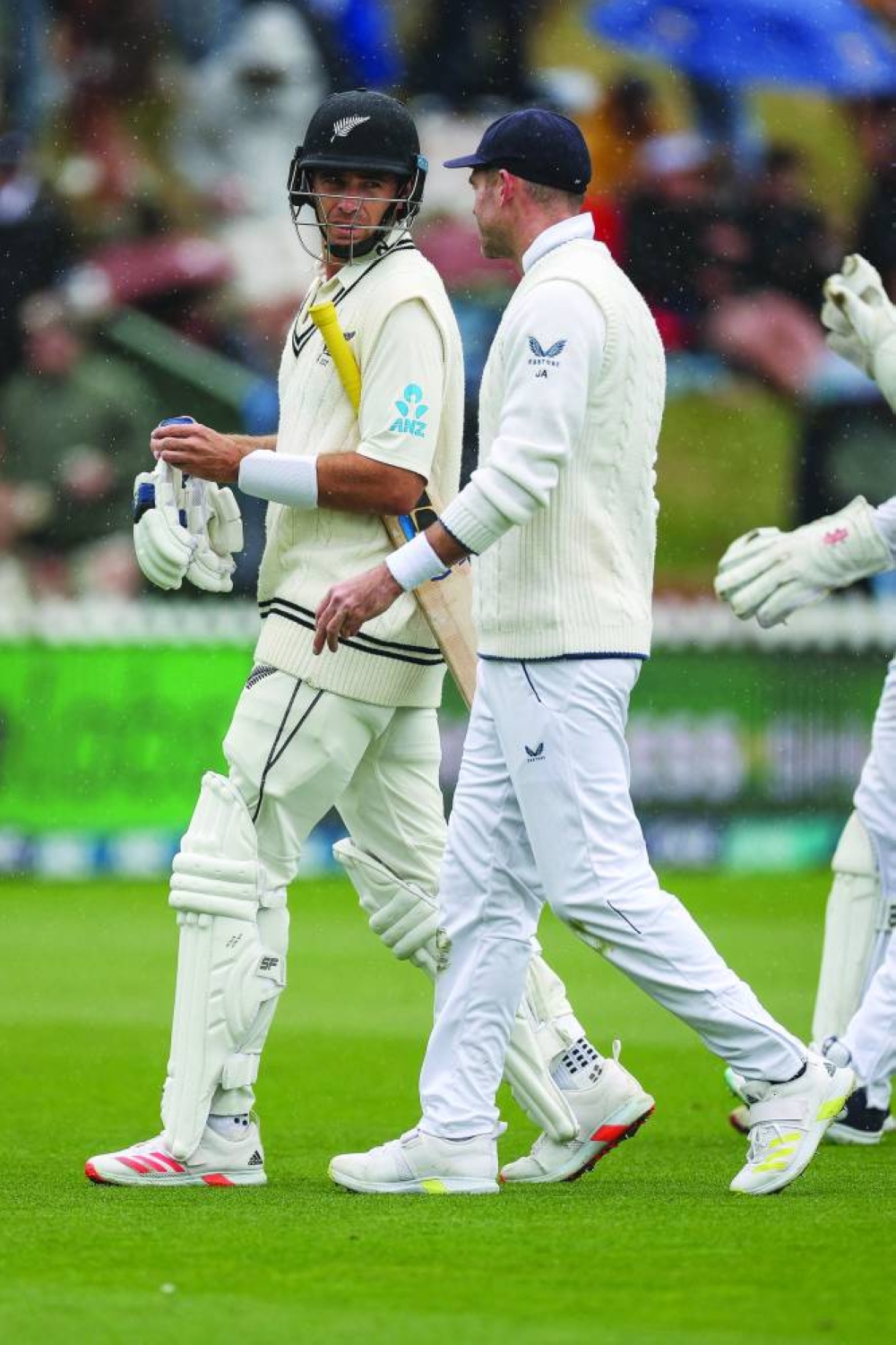 New Zealand’s captain Tim Southee (left) and England’s James Anderson walk off the field as the rain delays play during day two of the second Test. (AFP)