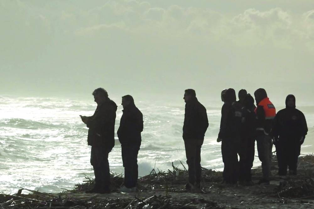 Rescuers work at the beach where bodies of refugees were found. (REUTERS)