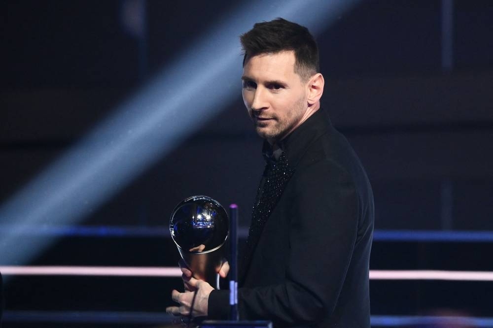 Argentina and Paris Saint-Germain forward Lionel Messi poses on stage after receiving the Best FIFA Men痴 Player award during the Best FIFA Football Awards 2022 ceremony in Paris February 27. AFP