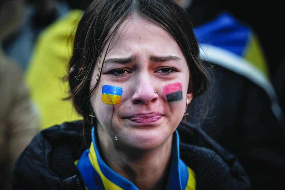 A young woman reacts during a rally marking the first anniversary of the Russian invasion of Ukraine in front of the Russian embassy in Copenhagen on Friday. (AFP)