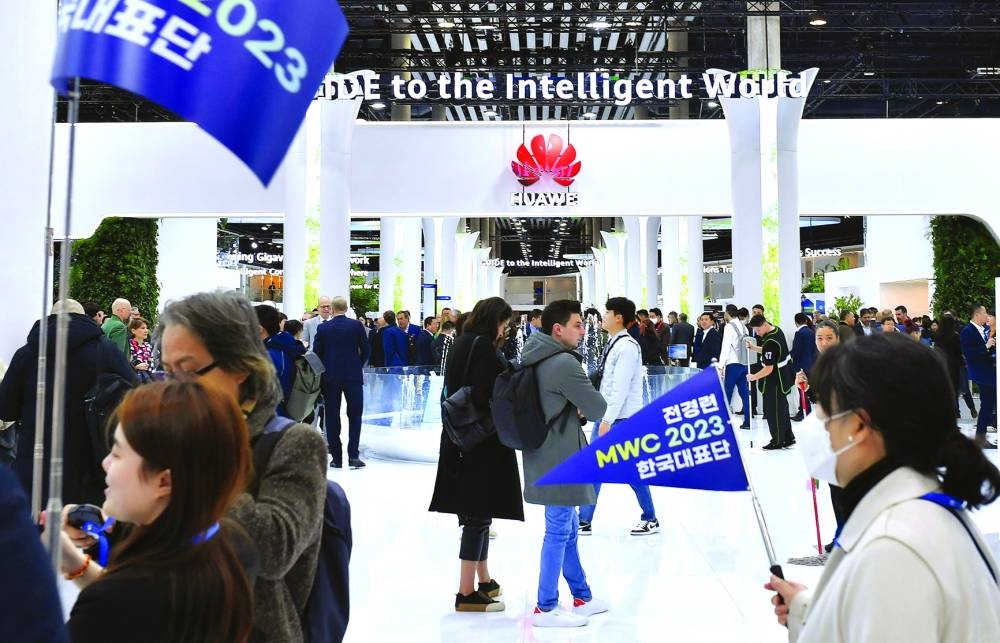 Visitors walk next to Huawei stand at the Mobile World Congress in Barcelona. Together with global industry customers, partners, and opinion leaders, Huawei discussed how digital technologies will affect our future – from the development of the world economy, through to global cultures, societies, and the environment.
