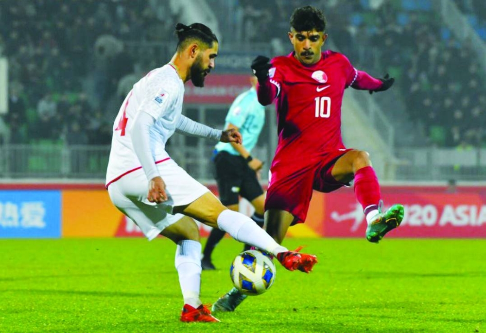     Qatar’s Jassem al-Sharshani tackles Iran’s M Torabi during their AFC U20 Asian Cup Uzbekistan 2023, Group B, match at the Istiqlol Stadium yesterday.


