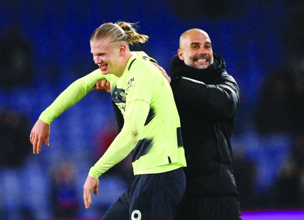 Manchester City’s Erling Haaland and manager Pep Guardiola celebrate after their team’s win over Crystal Palace in London. (Reuters)