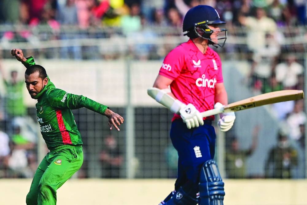 Bangladesh’s Mehidy Hasan Miraz (left) celebrates after dismissing England’s Sam Curran during the second Twenty20 in Dhaka yesterday. (AFP)