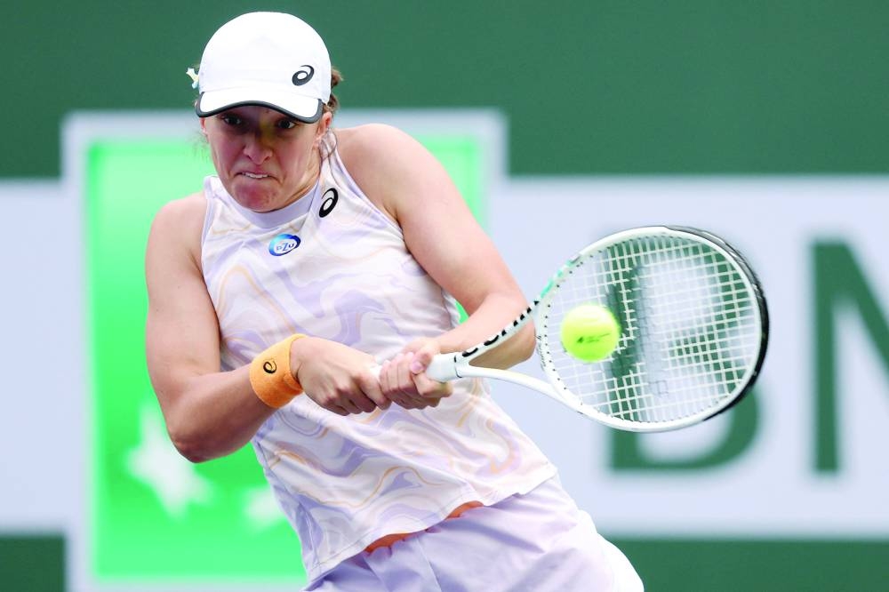 Iga Swiatek of Poland whips a doublehanded backhand during her match against Claire Liu of the United States. (AFP)