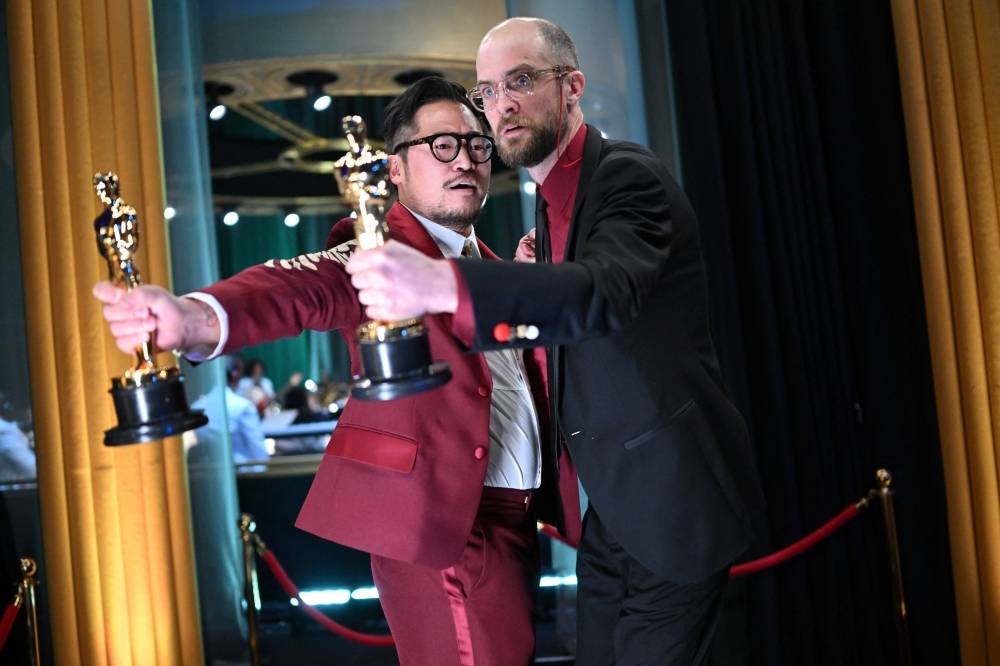 Directors Daniel Kwan and Daniel Scheinert pose with their Oscar for Best Picture for "Everything Everywhere All at Once" backstage during the Oscars show at the 95th Academy Awards in Hollywood, Los Angeles. REUTERS