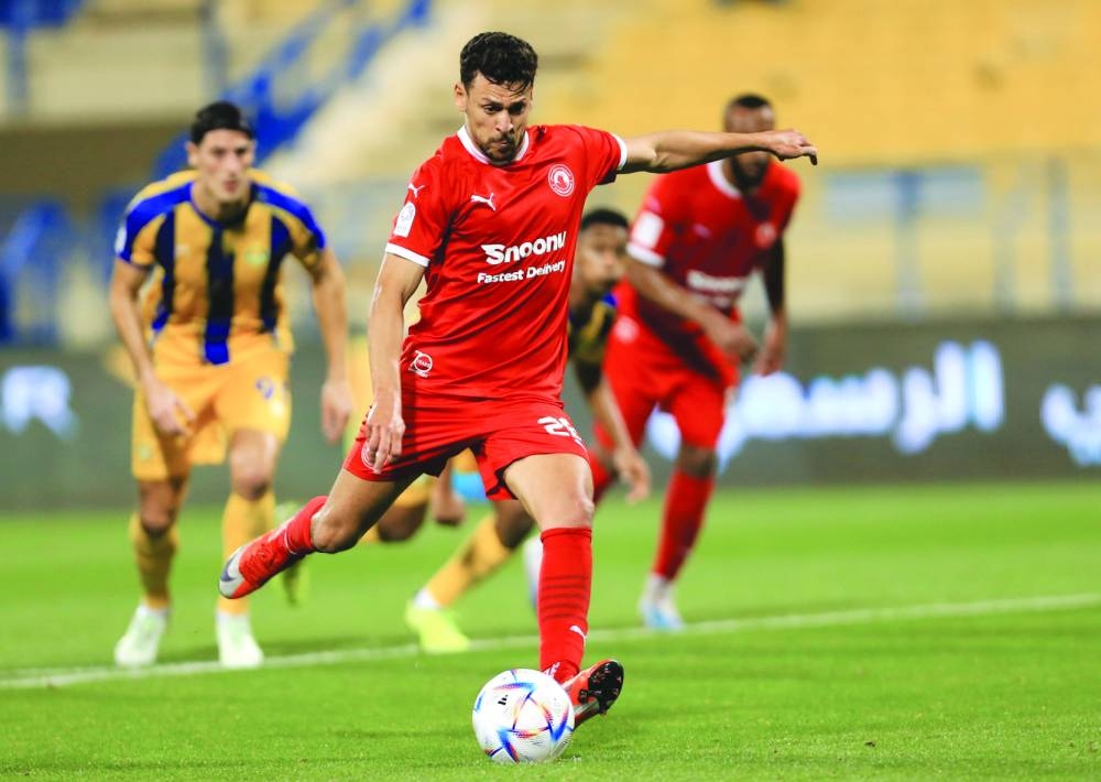 Al Arabi's Youssef Msakni converts a penalty during the QNB Stars League match against Al Gharafa at the Thani Bin Jassim Stadium on Monday.