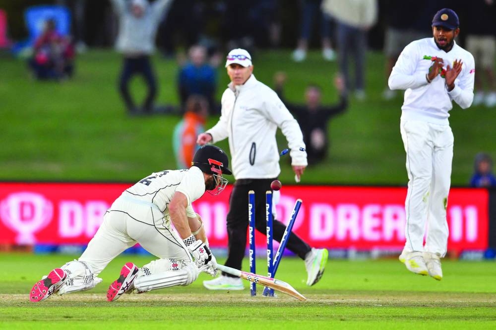 New Zealand’s Kane Williamson (left) completes a successful run to win the first Test against Sri Lanka in Christchurch. (AFP)