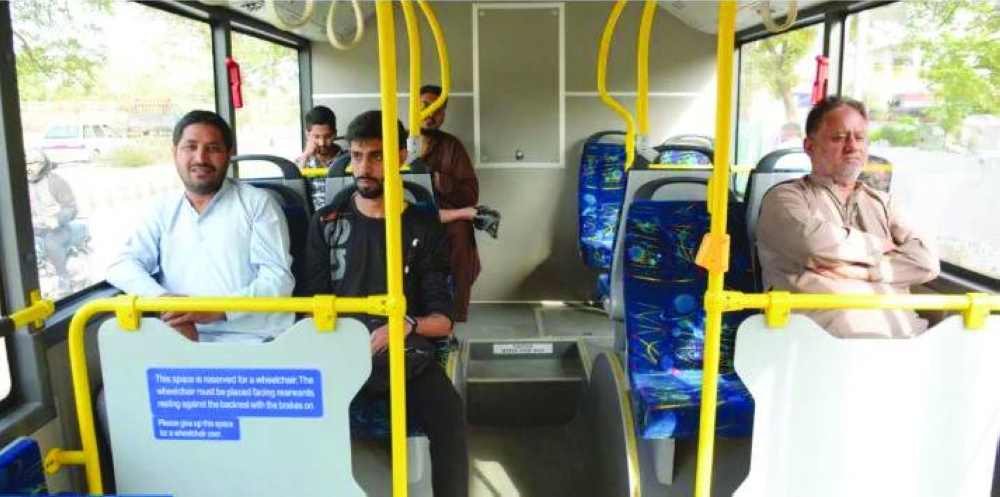 Citizens travel in the newly launched electric bus near the airport area in Karachi.