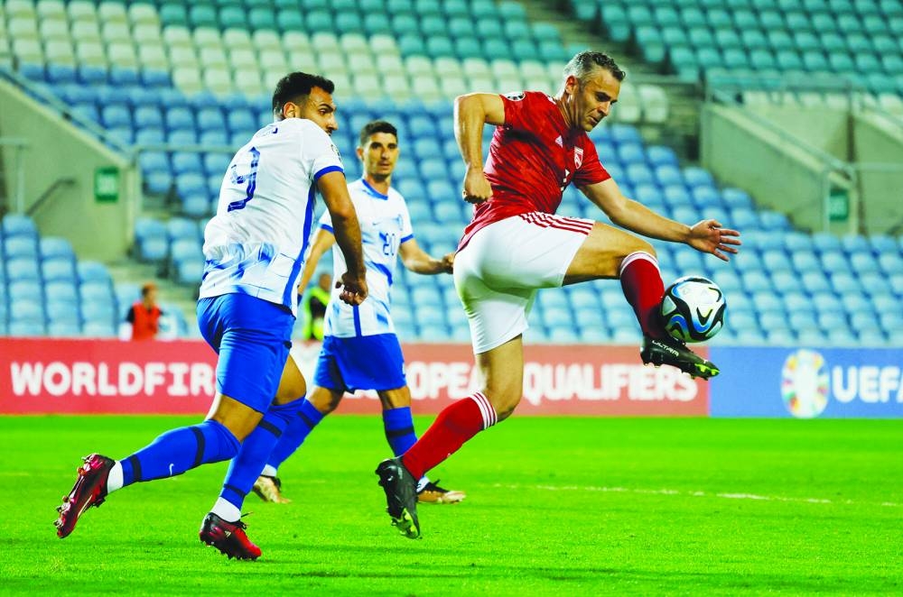 Gibraltar’s Lee Casciaro (right) vies for the ball with Greece’s Vangelis Pavlidis during the UEFA Euro 2024 qualifiers. (Reuters)